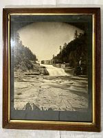 Full view of framed photograph showing waterfall scene and overall condition of frame and glass.
