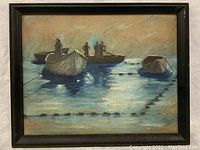 Front view of small antique oil painting showing three boats with figures on water at dusk, framed in black.