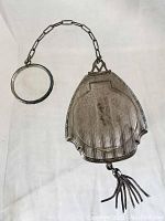 View of the Victorian sterling silver finger purse compact showing chain with circular finger ring and tassel detail.