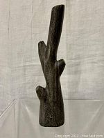 Front view of the vintage Inuit tree carving showing the overall form and texture.