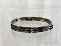 Top view of the closed vintage sterling silver bracelet showing the ribbed design of the curved links and clasp.