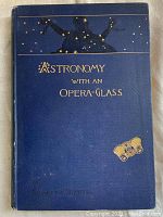 Front cover of the antique book showing the title, author, and constellation design in blue, gold, and black.