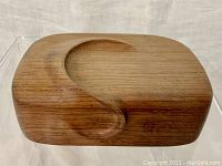 View of top surface showing carved design and matched wood grain.