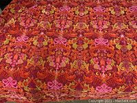 Close-up view of the colorful psychedelic chenille pattern with detailed floral motifs in shades of red, orange, pink, and green.