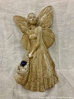 Front view of the cement or plaster fairy wall hanging figurine showing full figure and wings.