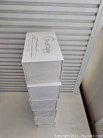 Stack of six sealed white boxes labeled TechCare Plus 24 on a white surface.