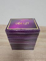 Stack of nine sealed purple and gold Tetyana Lash Lift kits.