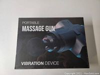 Sealed box of Ecardy portable massage gun showing brand and product type