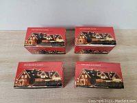Four unopened red boxes of Christmas decoration lights labeled 'Decoration Light 100% copper quality' showing an image of a house lit with string lights.