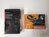 Boxes of the AstroAI 202D digital clamp meter and Lonove digital endoscope seen side by side, showing brand names and basic details.