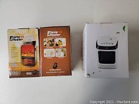 Three heater units in original packaging: two Flame Heater 900W wall plug heaters in boxes showing flame effect and remote control images, and one white LED desktop heater box.