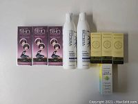 Photo showing 2 Bioterra styling gel bottles, 3 Cover Your Gray black hair fill-in powder boxes, and 3 small yellow boxes of Essynatruals hair growth oil.