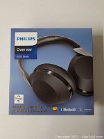 Front view of the Philips 8000 Series headphones box showing product image and key features: active noise cancelling, Bluetooth, touch control, Google Assistant compatibility.