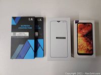 Two LK brand blue and black boxes containing screen protectors, plus two white smartphone boxes for Ulefone Note 8 and S30U+