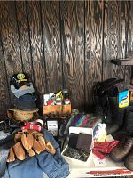 Lot overview showing boots, hats, scarves, shoe care box, and some belts