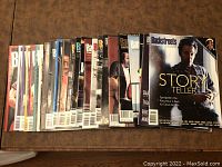 25 issues of Backstreets Magazine featuring Bruce Springsteen lined up side by side showing front covers.