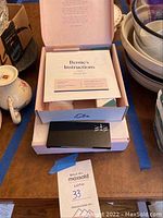 Open box showing 'Bernie's Instructions' and contents of one eSalon hair color kit with developer bottle and vials.