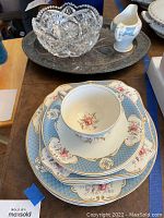 Photo shows stacked Myott Staffordshire china dinner dishes, salad plates, saucers, tea cup, cream pitcher on an oval silver plated tray, with the vintage cut glass bowl on the tray.