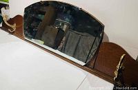 Wooden wall-mounted coat hook with mirror showing full length and hooks.