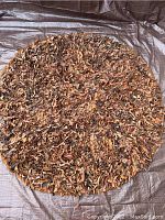 Top view of vintage round leather rag rug showing texture and color variation in leather strips.