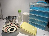 Photo of all kitchen items including cupcake holder, bowl, colander, dispensers, and containers