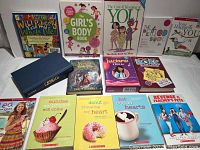 Top view of the books arranged in two rows including educational and fiction books for preteen girls about puberty and romance.