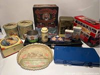 Full overview of the lot showing all tins, containers, and boxes arranged on a white surface