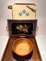 Photo showing all trays and wooden bowl together: large wooden tray (bottom), vintage MCM bed tray (top), metal and glass bird tray (middle), wooden bowl (center)