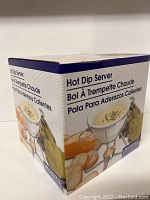 Photo of the Hot Dip Server new in box showing the product packaging with the front side of the box with the product name and serving suggestion image.