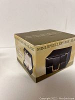 Closed box showing external packaging with product title and image.