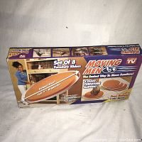 Box front showing product name, set of 8 furniture sliders with promo text and images.
