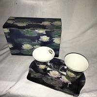 Photo of two water lily decorated ceramic mugs on matching rectangular tray in front of original McIntosh branded box with similar water lily design