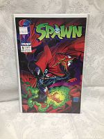Full front cover view of Spawn comic Issue No. 1 in protective sleeve, showing price sticker and condition.