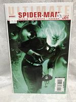 Front cover of the Ultimate Spider-Man Issue 1 comic book showing the character with glowing white hair holding a pendant in a dark green background.