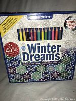 Front view of the new Winter Dreams coloring set box showing the 24 colored pencils and the title with a winter snowflake design.