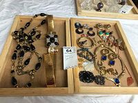 Photo of assorted costume jewelry including necklaces, bracelet, earrings, and a wide gold-tone belt in wooden trays
