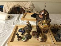 Overview of the lot on wooden tray, showing all incense pots, cloisonne style figurines, and pewter mouse figurine arranged together