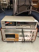 Top view of stacked Technics cassette deck and Sony stereo cassette receiver, showing the front panels with label and controls.