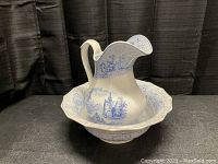Front view of the large water pitcher and bowl set showing blue transferware patterns and general condition