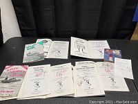 Overview of entire lot showing six Cape Cod-themed paperback books signed by Noel Behle.