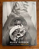 Front cover of the hardcover book showing an overhead view of a complex metal sculpture installation, with title and author text.