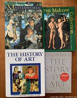 Four art history books arranged on a floor