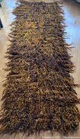 Full top view of the shaggy goat hair rug showing dense textural pile and long irregular strands.