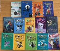 Image of 16 children's novels including the entire Worst Witch series by Jill Murphy, Beverly Cleary's books, and other titles, arranged on a wooden surface.
