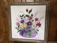 Full view of the framed floral painting with signature and decorative frame.