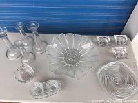 Top view of the collection showing all items including large flower-shaped bowl, candlesticks, ashtrays