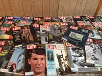 Close-up view of LIFE magazines with different cover topics and visible signs of wear.