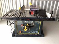 Full view of the Mastercraft 10 inch bench saw on a metal base with power cord attached, showing top table and fence arrangement.