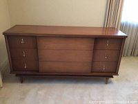 Full front view of the wooden retro cabinet showing drawers and sliding door panel