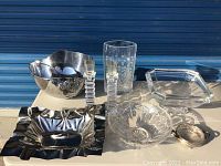 Overview of serving decor items on table including metal and glass pieces